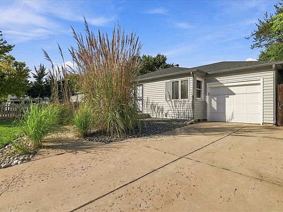 1 Car attached garage, long driveway, front yard, and porch.