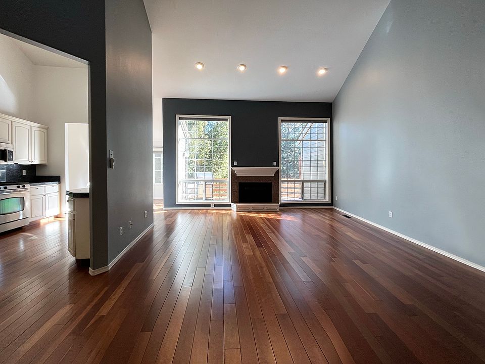 Living room with gorgeous hardwood floors, stunning natural light and 15''+ ceilings.