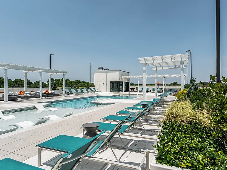 Lounge chairs on the side of Rooftop Pool
