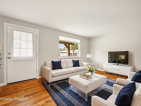 Step into a sunlit living room where natural light fills the space, creating a warm and welcoming atmosphere.