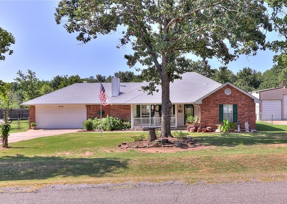 Well maintained home on small acreage with large shop, storm shelter and a welcoming front porch.