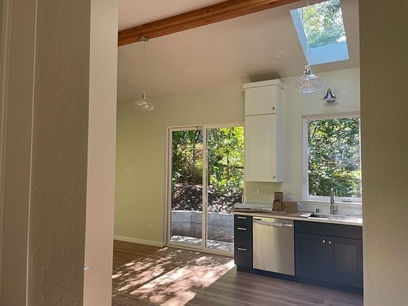Walk into small entry with skylights and high ceiling