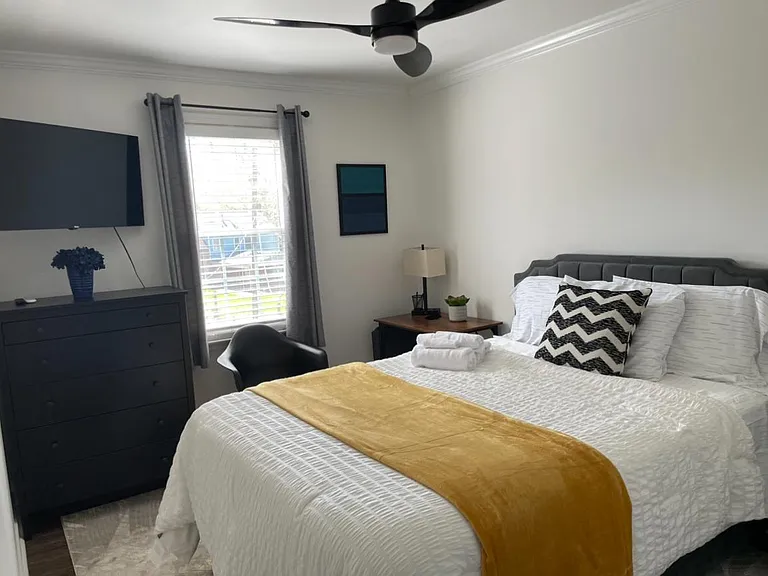 Well-appointed bedroom w/Queen bed and dedicated workstation, full blackout curtains and 40" Roku TV for streaming