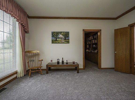 Living room withbrick fireplace, large windows