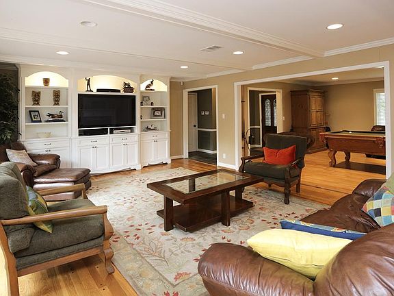 The light filled den is large and open to the formal living (used as a gameroom) and kitchen. Custom