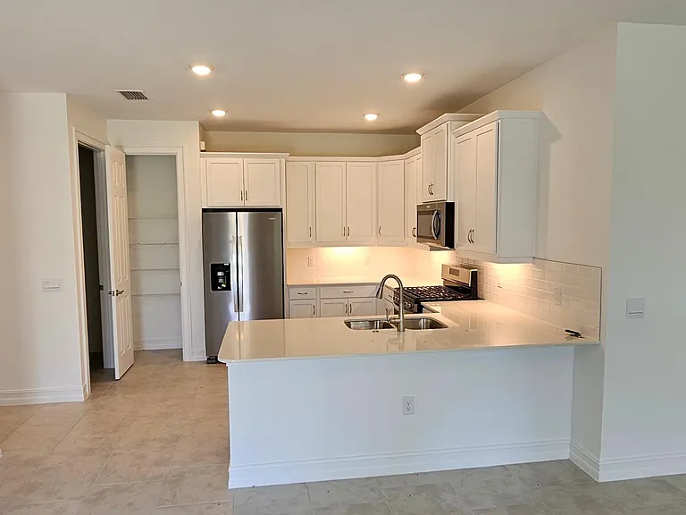 Kitchen of all stainless-steel appliances.