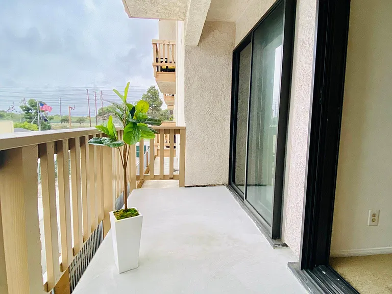 Balcony connecting with both bedrooms.