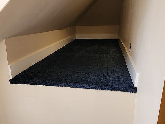 Storage area by entrance stairs