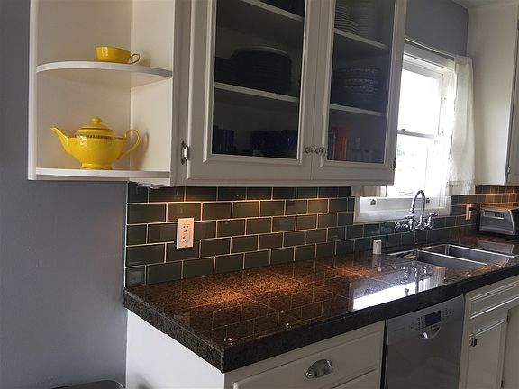 Updated kitchen with some glass front cabinets, granite counters, under cabinet lights.