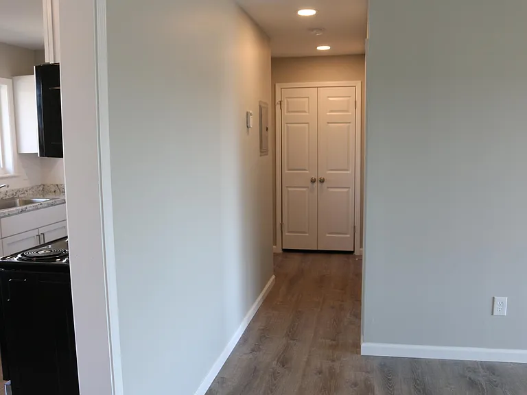 Recessed lighting installed in the hall area of the apartment.