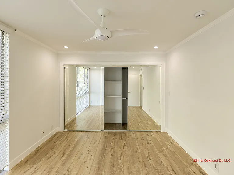 Large Closets with Mirrored Doors and Built-In Organization