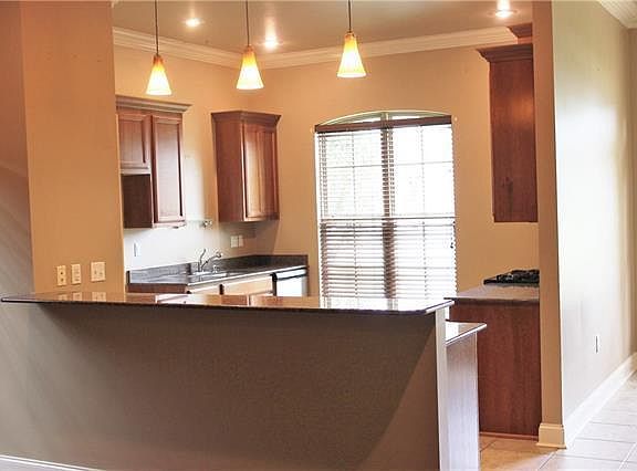 Granite counters/ wood cabinets with stainless steel appliances