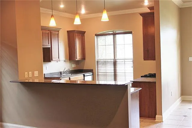 Granite counters/ wood cabinets with stainless steel appliances