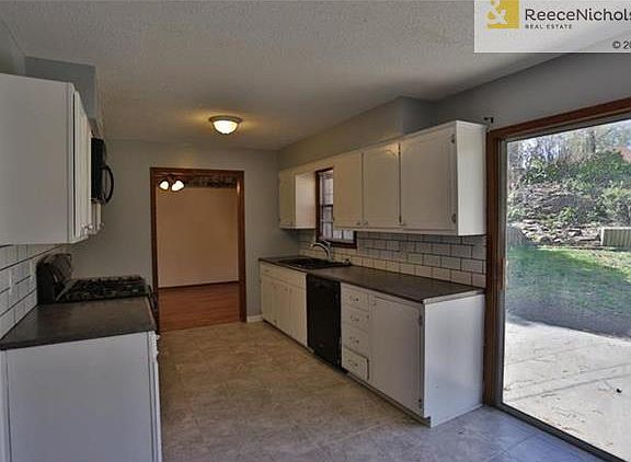 New tile floors and subway tile backsplash in kitchen