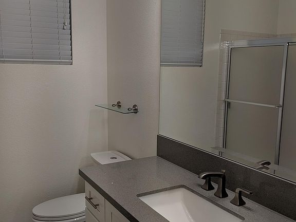 Bathroom renovated in May of 2019: Quartz countertop, shaker cabinets, LED lighting, polished concrete flooring.