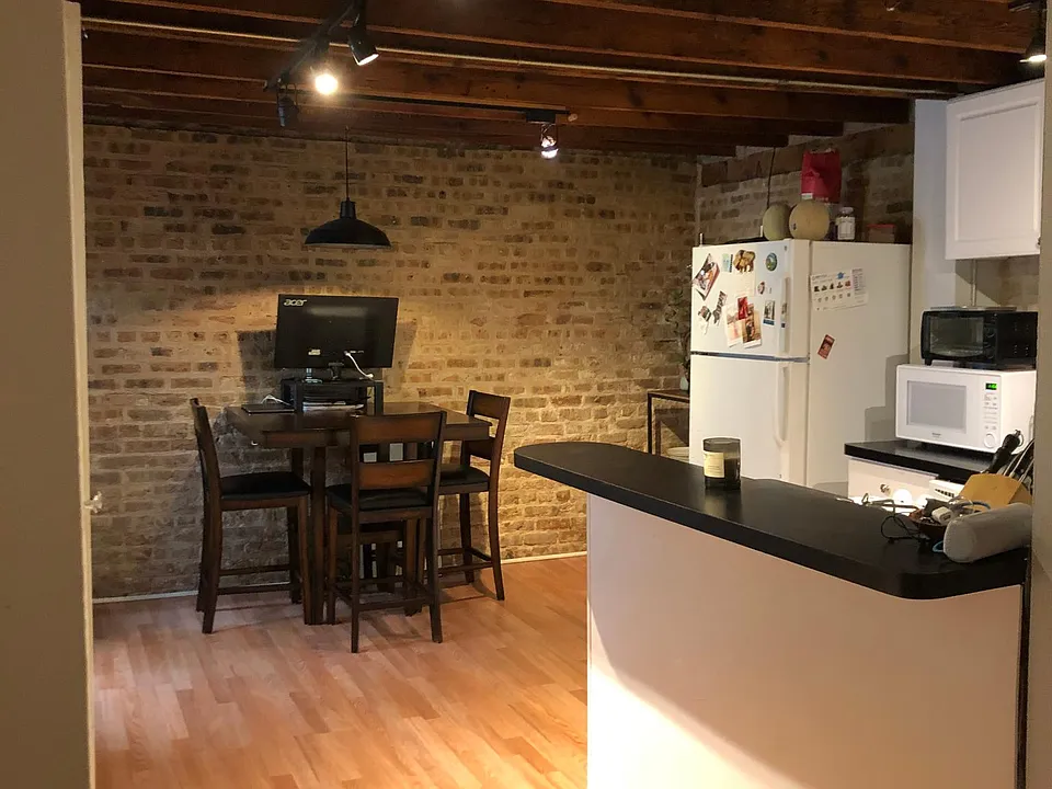 Room for bar stools. This room has been updated and painted all white. Track lighting. Front door and stairs to upper floor to the left