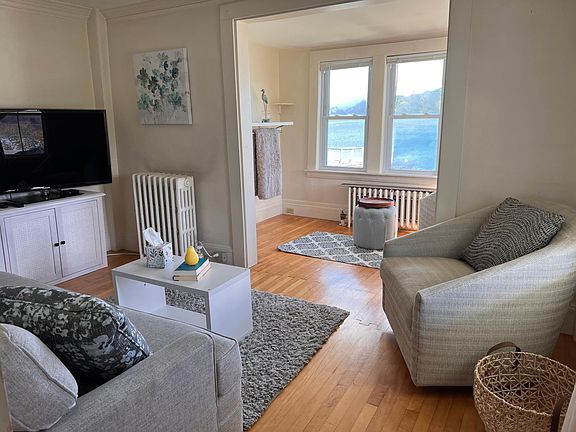 Fully furnished living room with views of the river. TV included however bring your own streaming service / device.