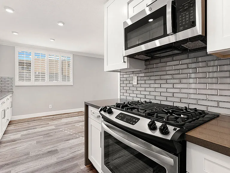 Wrap around kitchen with stainless steel microwave and oven.