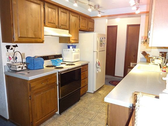 Bright and cheerful kitchen has nice counter space and cabinets. Pantry just around the corner!. All appliances stay. Has dishwasher and disposal.