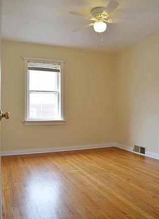 Main floor master bedroom with hardwood floor and ceiling fan!