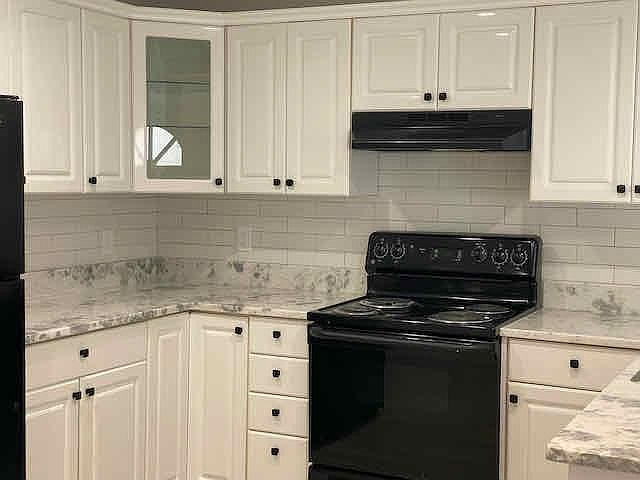 Updated kitchen with granite countertops and subway tiled backsplash