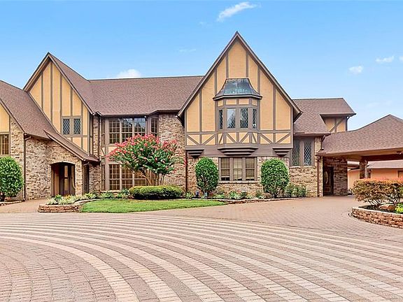 IMPRESSIVE View pulling up to the Front of the Home! Notice the ALL the Parking, including the Porte Cochere to the right leads back to the 5 Car Garage Behind it.
