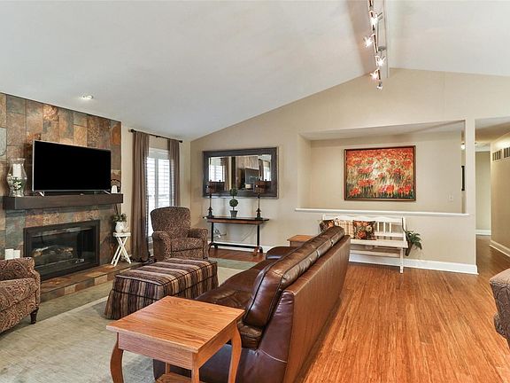 Open staircase in great room leads to finished lower level