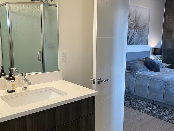 Bathroom with quartz countertops and shower stall