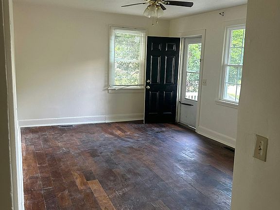 View of living room from hallway and front door.