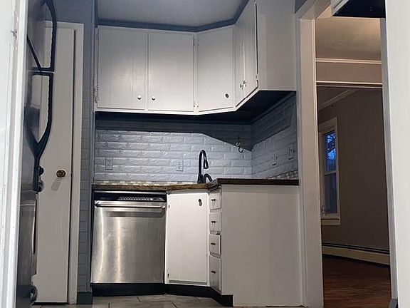 Renovated Kitchen with track lighting and ceramic tile floor