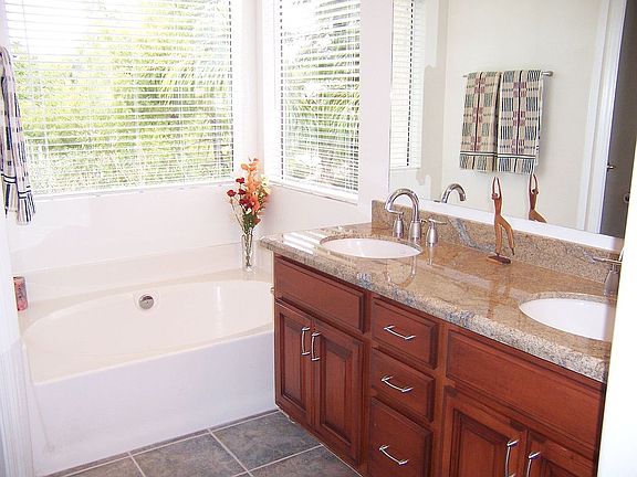 MORE granite and cherry cabinets in baths.  Also tile surrounds.