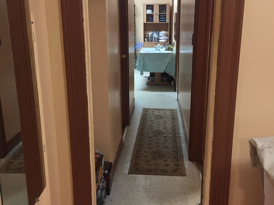 Apartment Hallway towards Eat-in Kitchen. Bathroom on left. Available room on right.