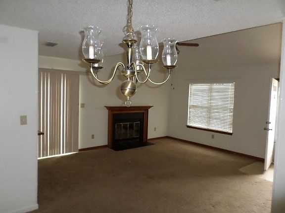 Living area from dining area. Front door to right. Sliding door to deck on left.