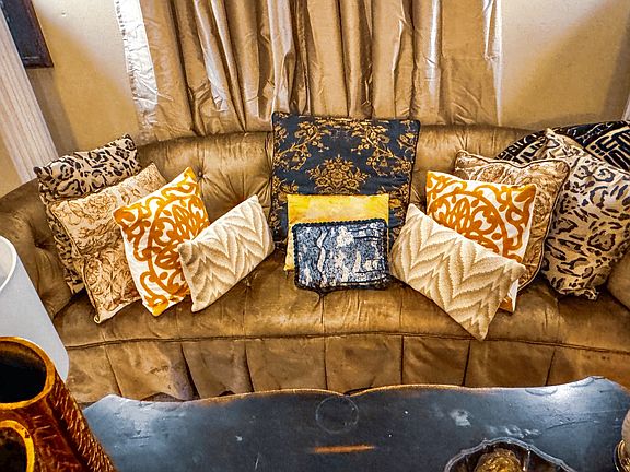 Sumptuous front parlor with pillowed sofa, a Dorothy Draper original.