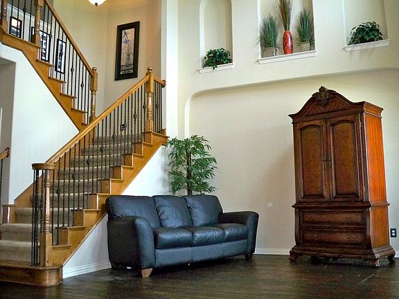 Front Formal Living Room with Wrought Iron Stair & Handscraped Hardwoods