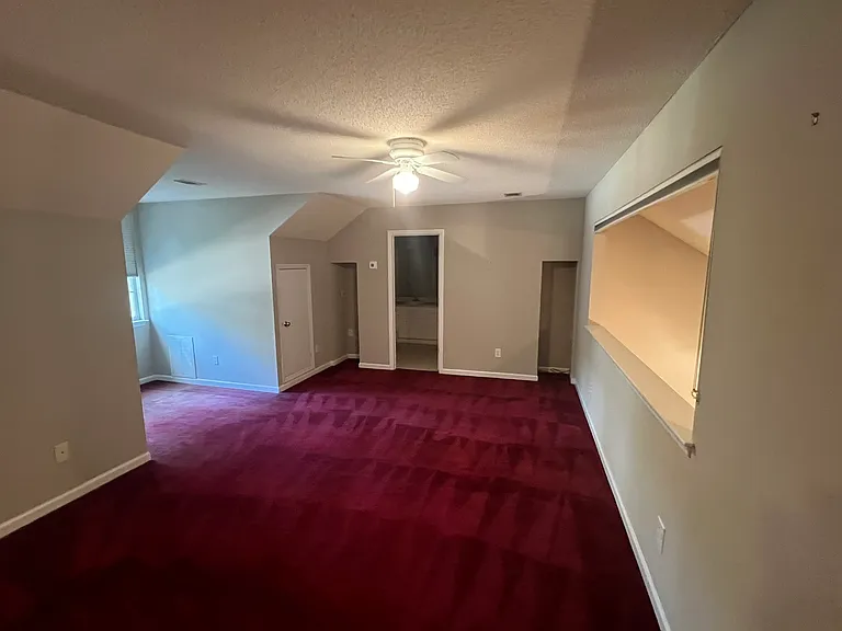 Upstairs bonus room with lots of attic storage space, bathroom with walkin shower, and large storage closet