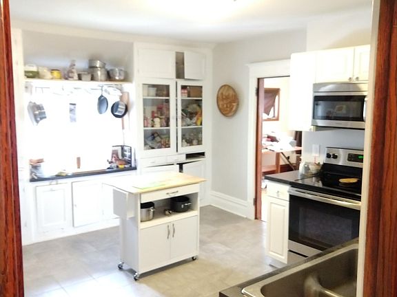 Large kitchen. All stainless appliances. New oven (2026). New microwave (2026). Built-in cabinets.