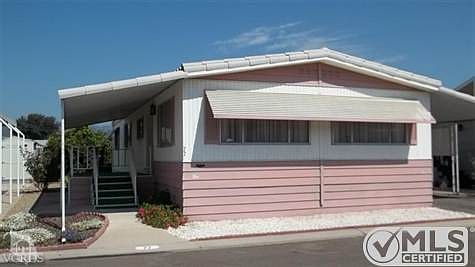 Lowest Priced Listing in the Park!!  Nice 1975 2 bedroom + 1-3/4 bath home with dishwasher, wall oven, gas cook-top, built-in buffet, breakfast bar, master bedroom with large walk-in closet and that's JUST THE INTERIOR.  50 year tile roof, lovely covered front porch, wooden shed, fruit trees, cement walk-way around entire unit and lots of room to garden!