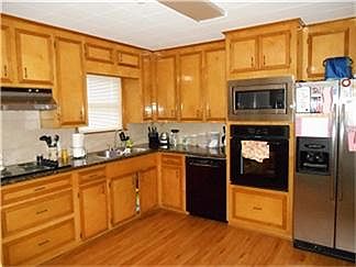 Wow! Gourmet kitchen complete with granite countertops, new appliances, wood linoleum floors,