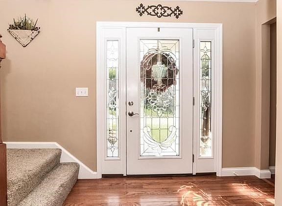 Gorgeous leaded glass front doors at front porch.