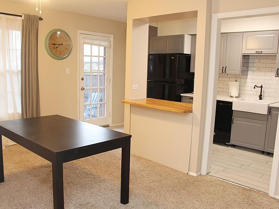 Dining room and kitchen. Door to backyard.