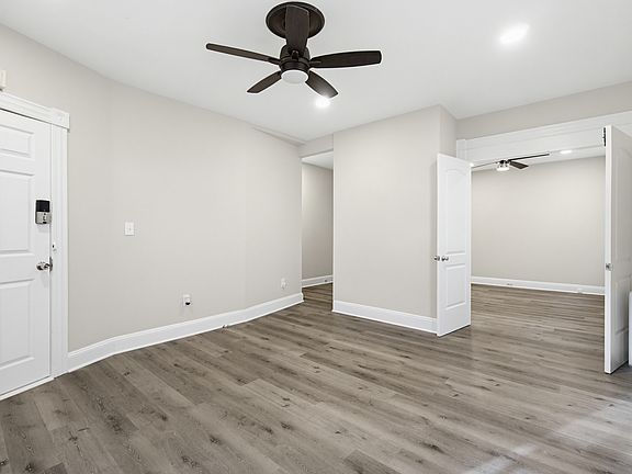 The french doors open up into the living room from the smaller bedroom/office.