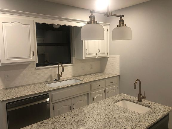 White oak cabinets with granite counter tops and farm sink.