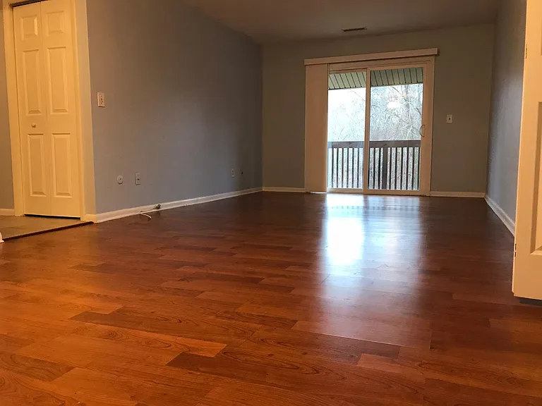 Living room w/balcony door.