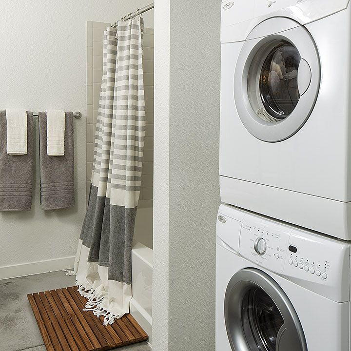Apartment Bathroom with soaking tub and in-home washer and dryer.