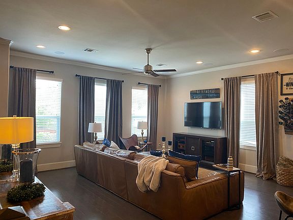 Dark stained hardwoods accent every room in the home. Drapes are installed and can remain.