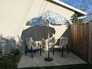 One of two rear patios, this one is on the side with concrete pad