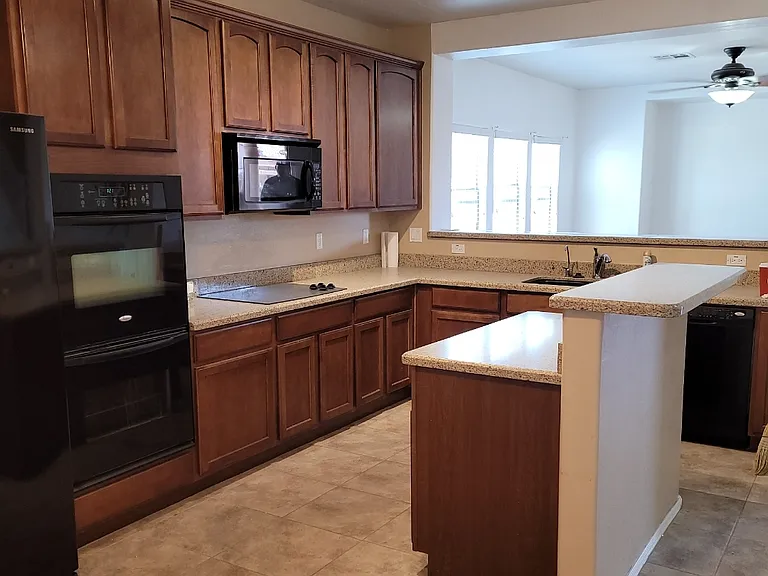 All appliances are furnished. Refrigerator, double oven, electric cook top, microwave, and dishwasher. Granite breakfast bar and room for small dining table. Full size pantry.