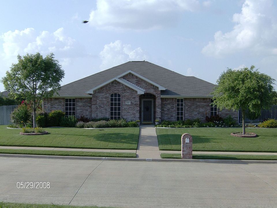 Front view of home and extensive perrenial landscaping