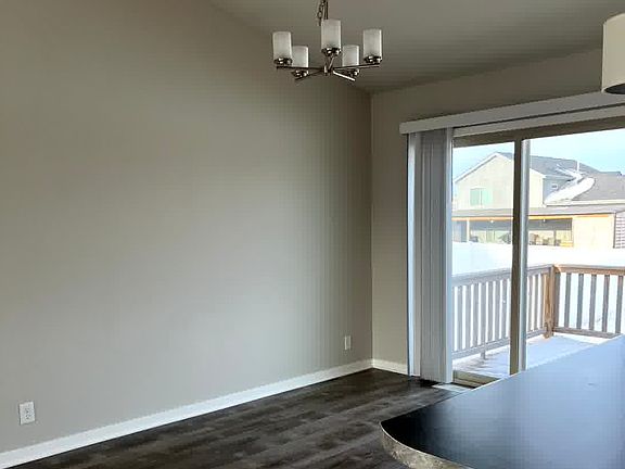 Dining room, sliding door leading to deck and cement patio with fenced-in yard.